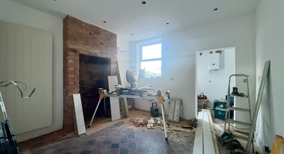 Living Room under renovation, with workman's tools and unfinished walls